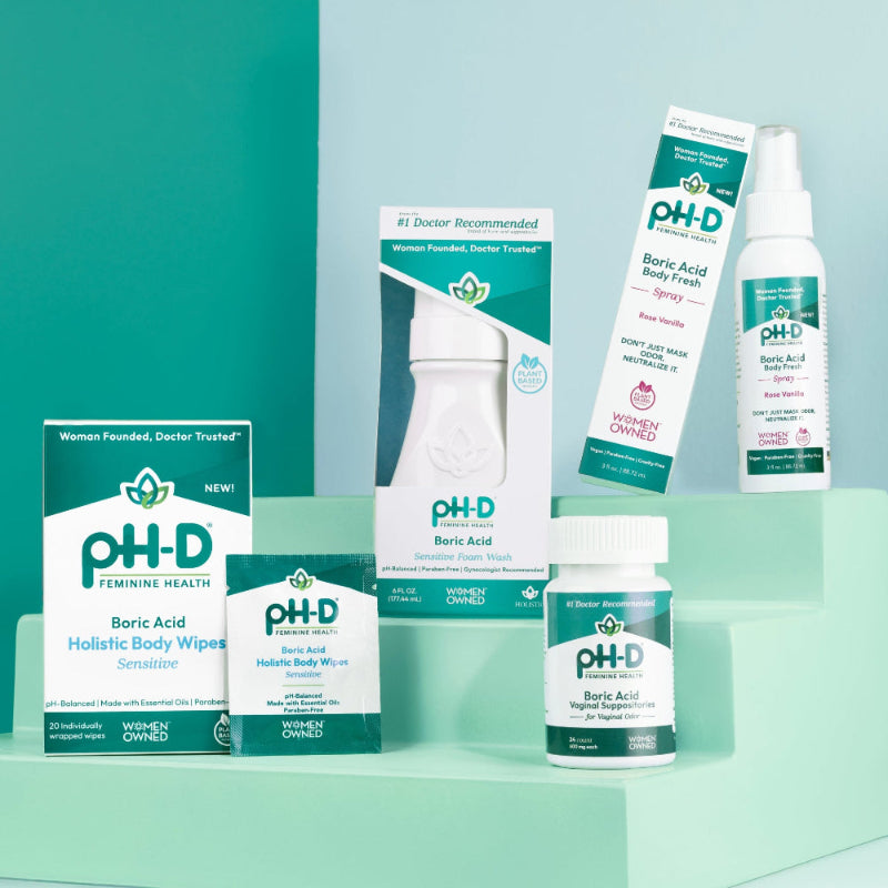 A collection of pH-D branded feminine hygiene products displayed against a teal background, including suppositories, spray, wipes, and foam wash.