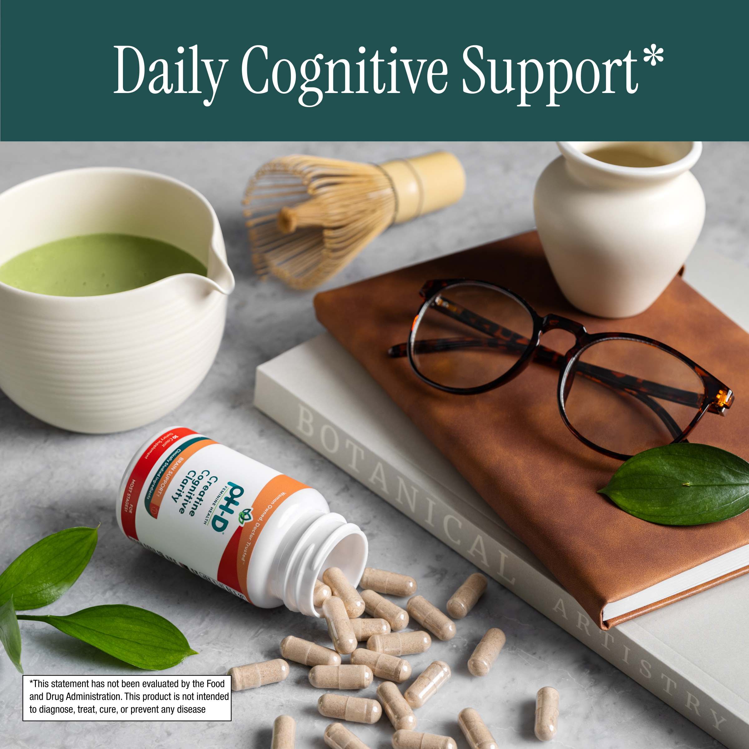 pH-D Creatine Cognitive Clarity with capsules on a table with a book, glasses, and green tea.
