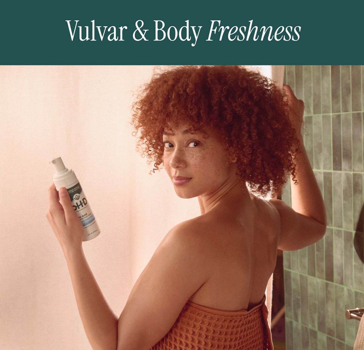 A woman with curly red hair in a shower setting holds a bottle of pH-D Feminine Health Boric Acid Foam Wash. A dark teal banner at the top features the text 'Vulvar & Body Freshness' in white.