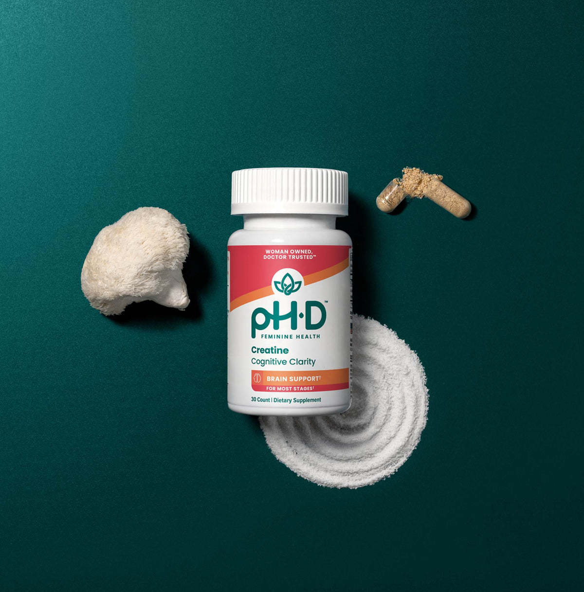A bottle of pH-D Creatine Cognitive Clarity dietary supplement is displayed on a dark teal background, styled with a raw creatine stone, a white powder swirl, and a brown creatine pill.