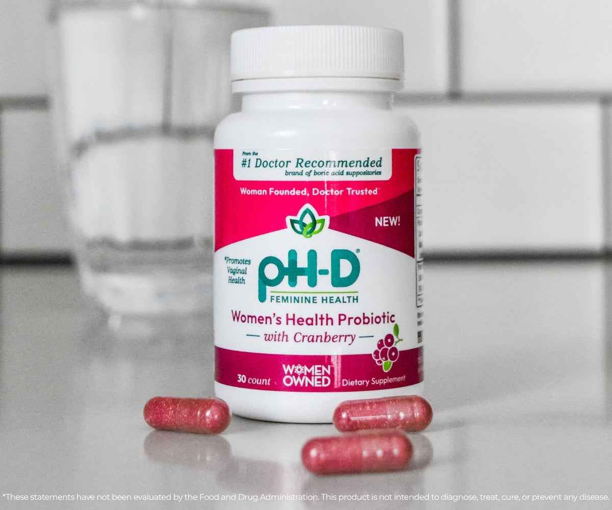 pH-D Feminine Health Probiotic bottle with capsules on a counter top