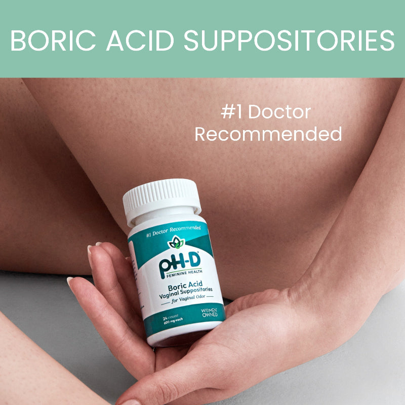 Bottle of PH-D Boric Acid Suppositories held by a hand with a blurred background