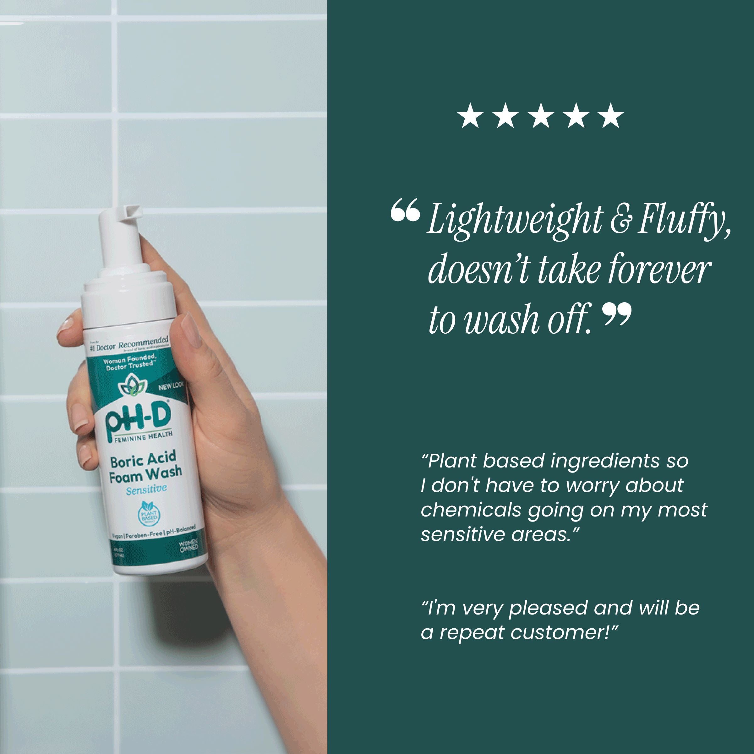 Hand holding a bottle of pH-D Boric Acid Foam Wash against a tiled wall background.