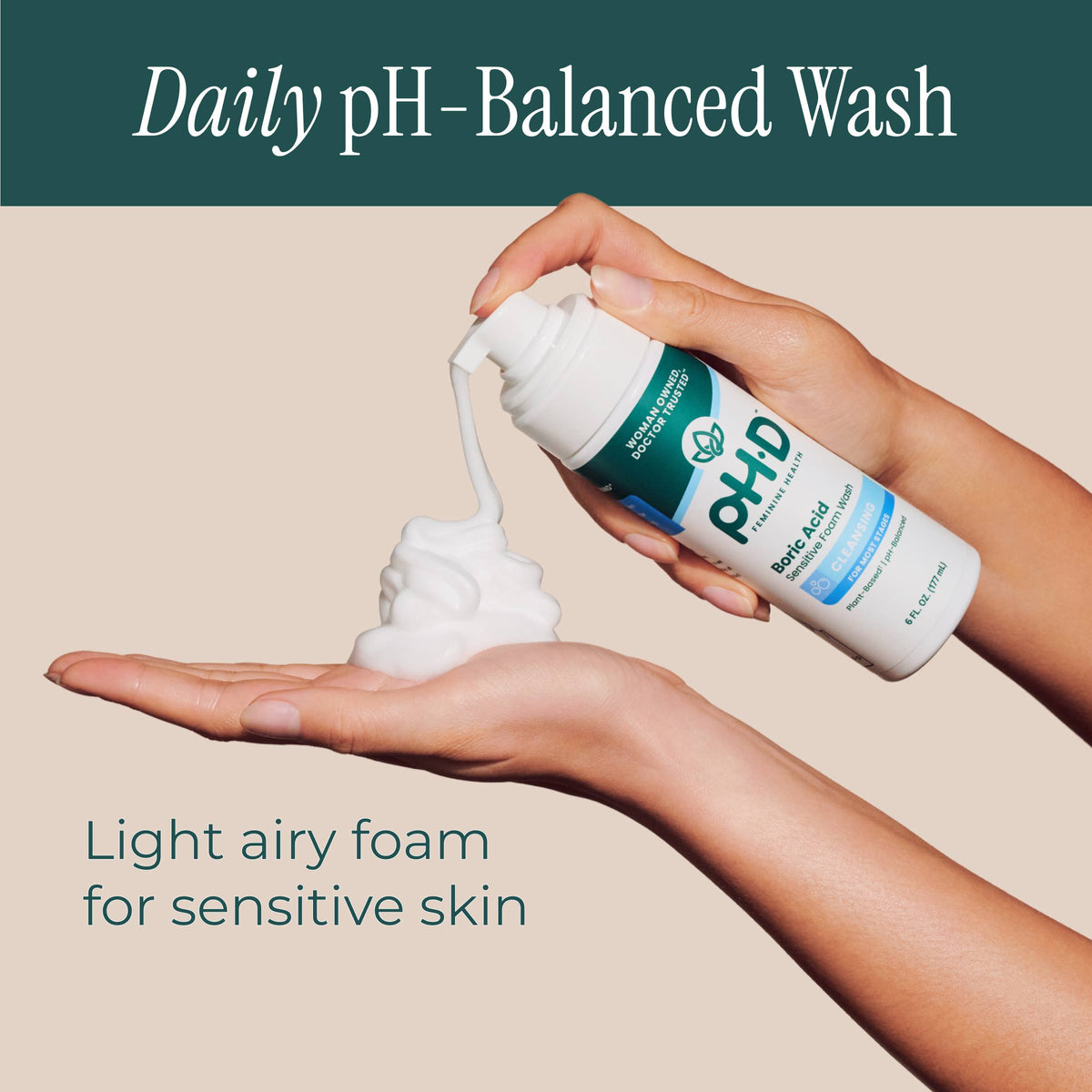 A hand holds a pump bottle of pH-D Feminine Health Boric Acid Foam Wash.