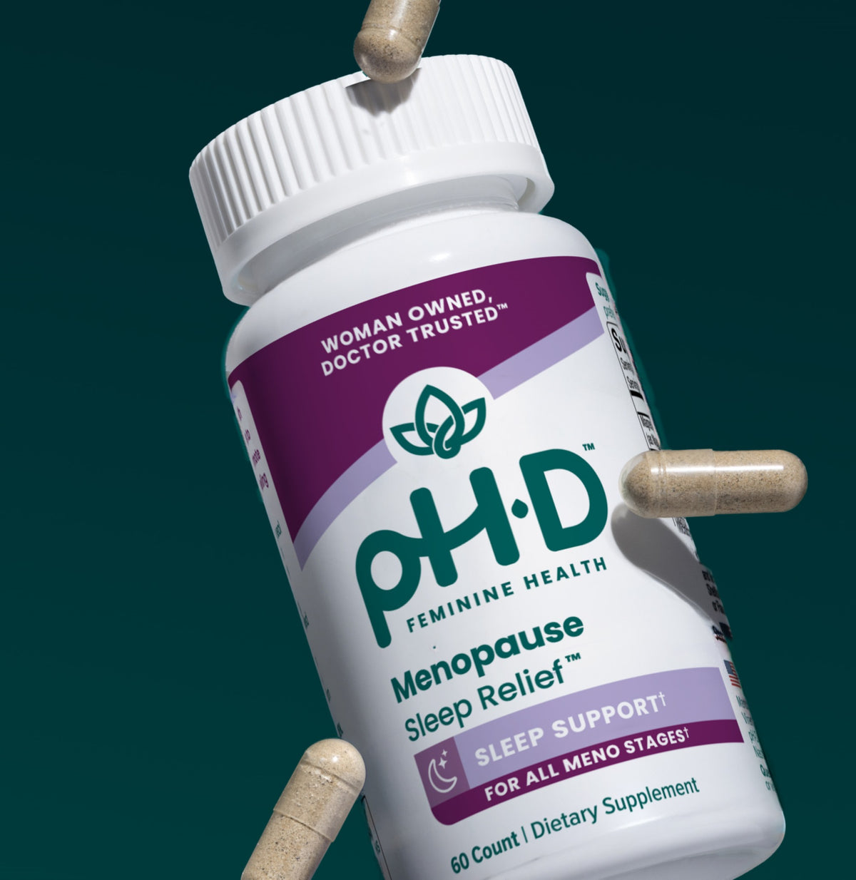 A white bottle of  pH-D Menopause Sleep Relief dietary supplement, shown at an angle with several beige capsules floating around it against a dark teal background.